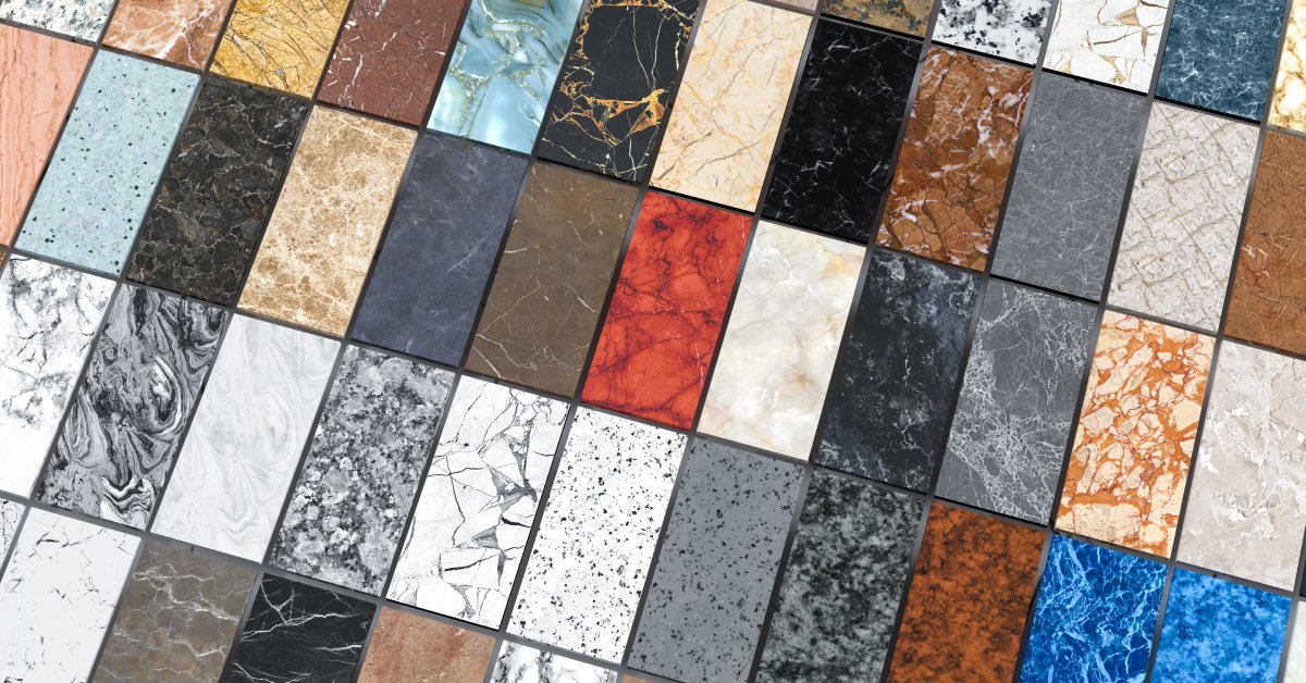 Several sample-sized slabs of veined quartzite in various colors on display. Between each sample is dark gray grout.